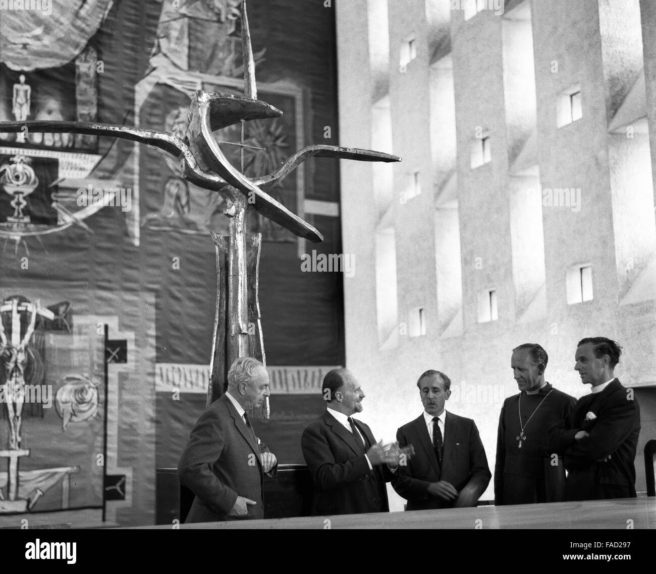 Members of the team responsible for the new Coventry Cathedral standing under the Cross of Nails in the newly-completed building, 23rd May 1962. (from second left) Scottish architect Basil Spence, building contractor Kirby Laing, Bishop of Coventry Cuthbert Bardsley and the Provost, the Very Reverend Harold Williams. Stock Photo