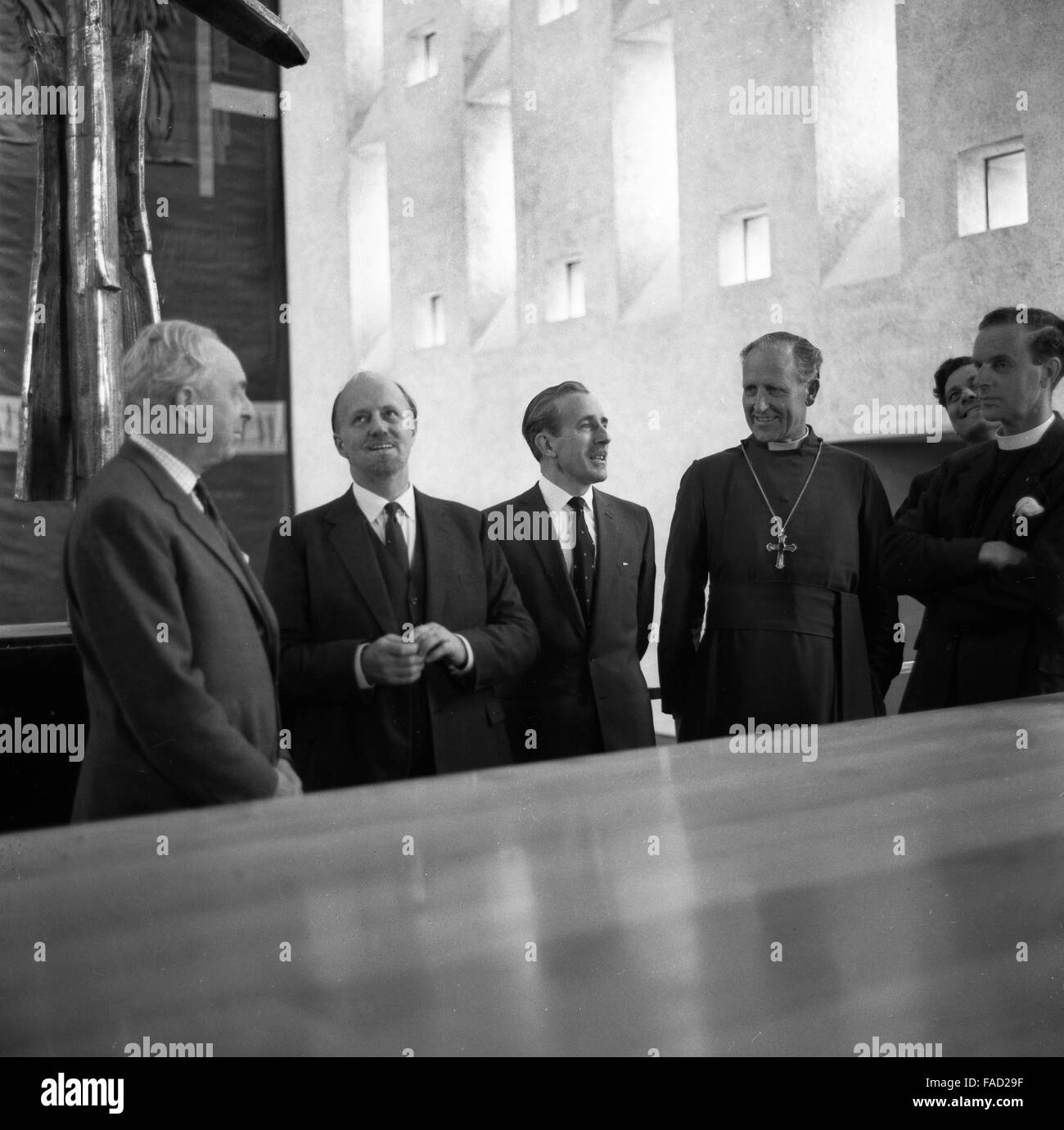 Members of the team responsible for the new Coventry Cathedral standing under the Cross of Nails in the newly-completed building, 23rd May 1962. (from second left) Scottish architect Basil Spence, building contractor Kirby Laing, Bishop of Coventry Cuthbert Bardsley and the Provost, the Very Reverend Harold Williams. Stock Photo