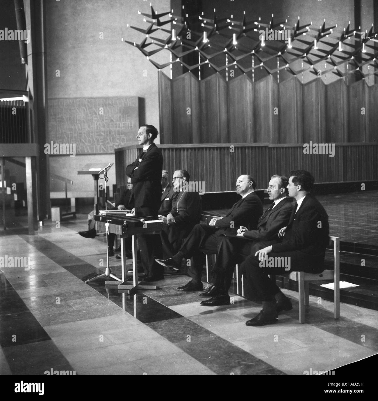 Provost of the Cathedral Very Reverend Harold Williams speaking Coventry Cathedral newly-completed building, 23rd May 1962. seated from left Bishop of Coventry Cuthbert Bardsley, Scottish architect Basil Spence building contractor W.K. Laing. Stock Photo