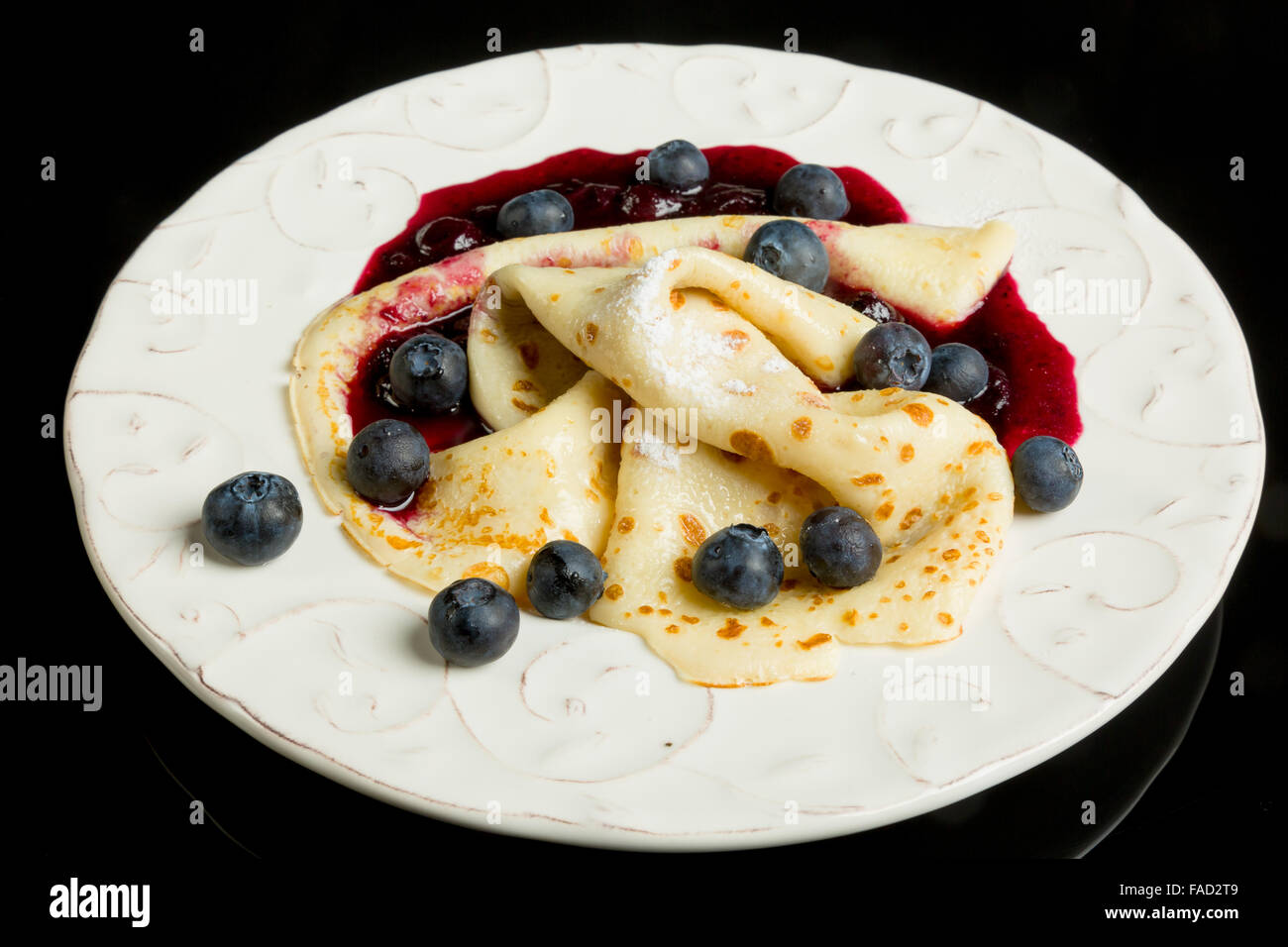 Small dessert. Pancake with blueberry sauce and blueberries. Stock Photo