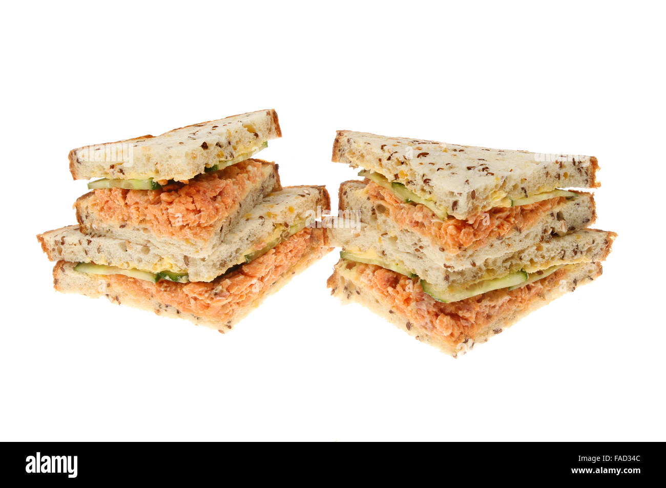 Salmon and cucumber sandwiches made with soya and linseed bread isolated against white Stock Photo