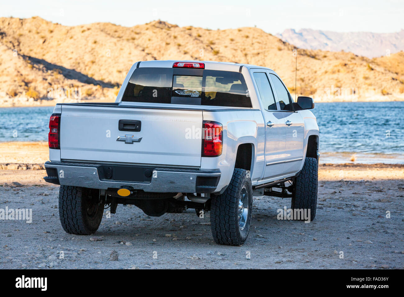 A Chevrolet 4 wheel drive truck at Lake Mohave near Laughlin Nevada as the sun sets Stock Photo