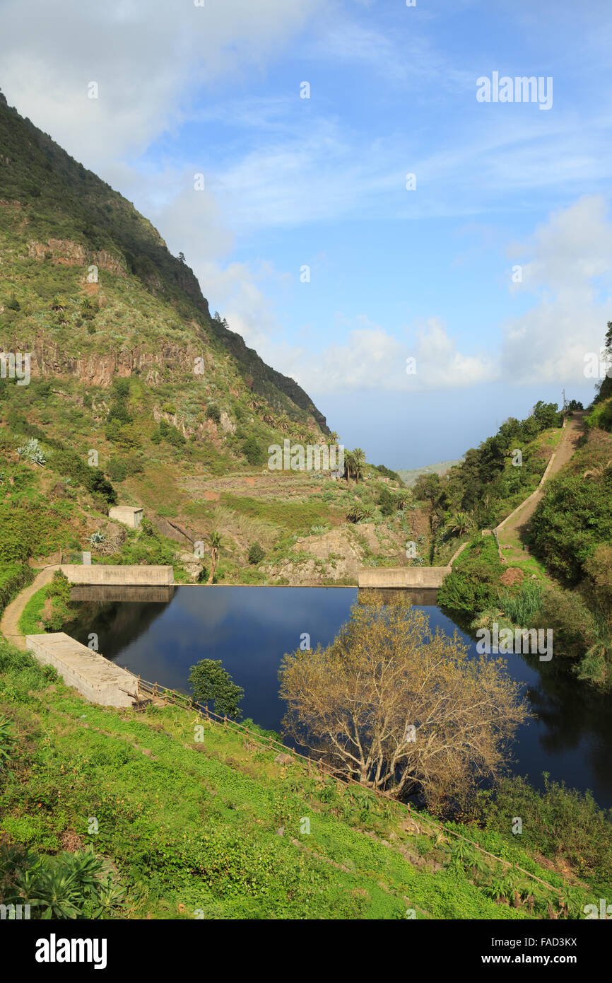 A landscape photograph of Embalse des los Tiles, a man-made dam near Hermigua in La Gomera, Canary Islands. Stock Photo