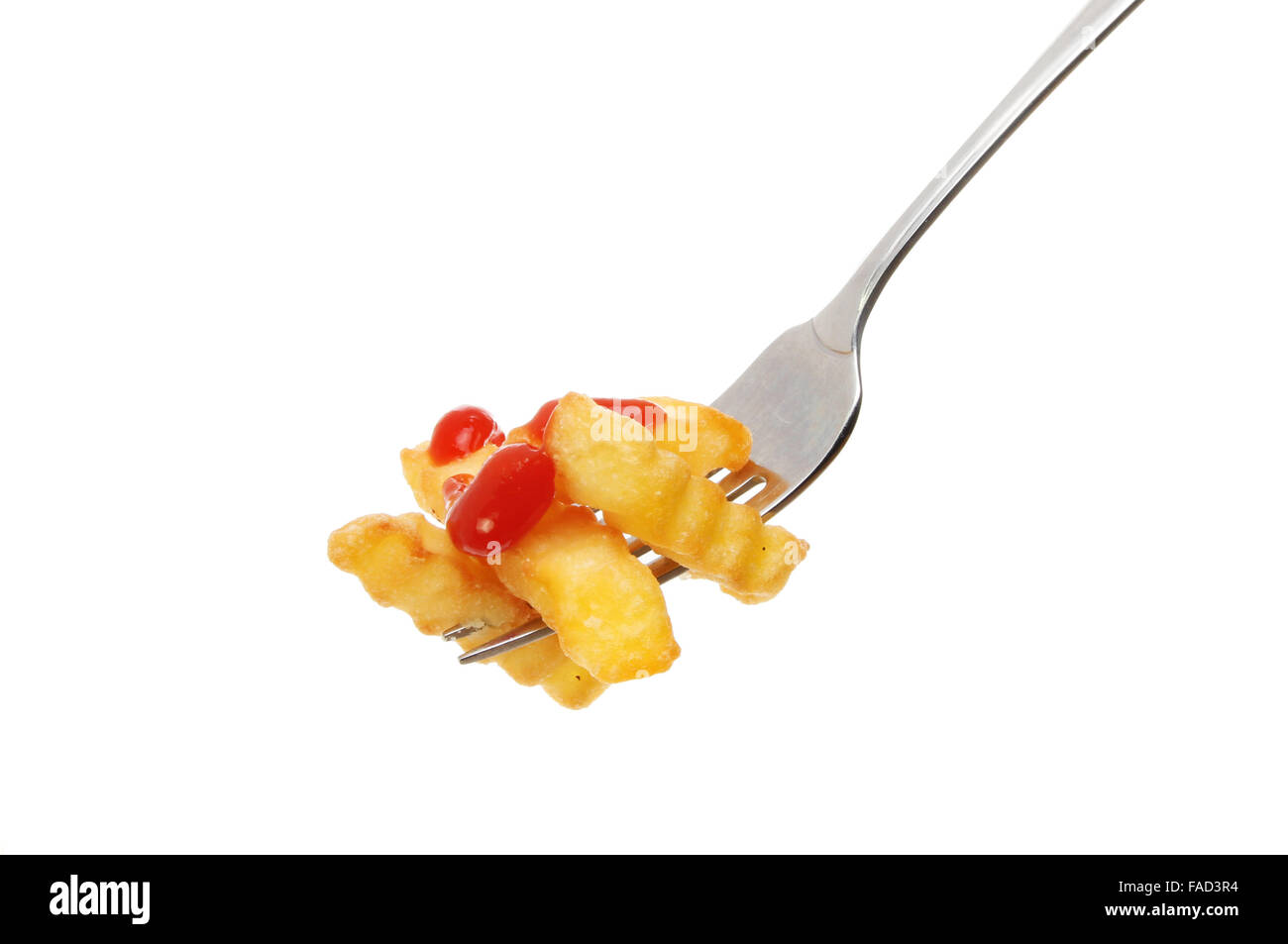 Crinkle cut potato chips with tomato ketchup on a fork isolated against white Stock Photo