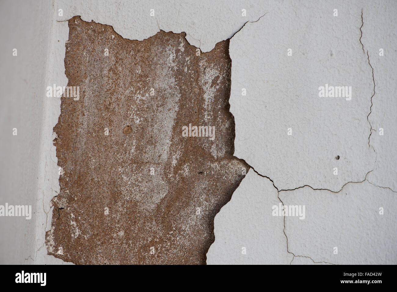 White paint peeling off a wall Stock Photo