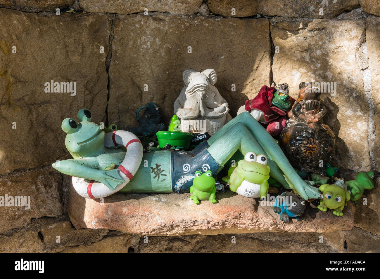 The very unique and fanciful 'frog shrine' located on a low rock wall on Paterna Road in Santa Barbara's Riviera neighborhood. Stock Photo