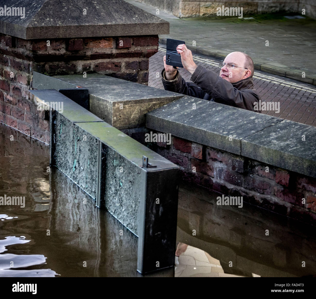 York, UK. 27th December, 2015. Widespread disruption continues in York due to flooding of the River Ouse and River Foss.  The floods have become a tourist attraction for residents and visitors as the Ouse reaches record levels in the city centre. Photo Bailey-Cooper Photography/Alamy Live News Stock Photo