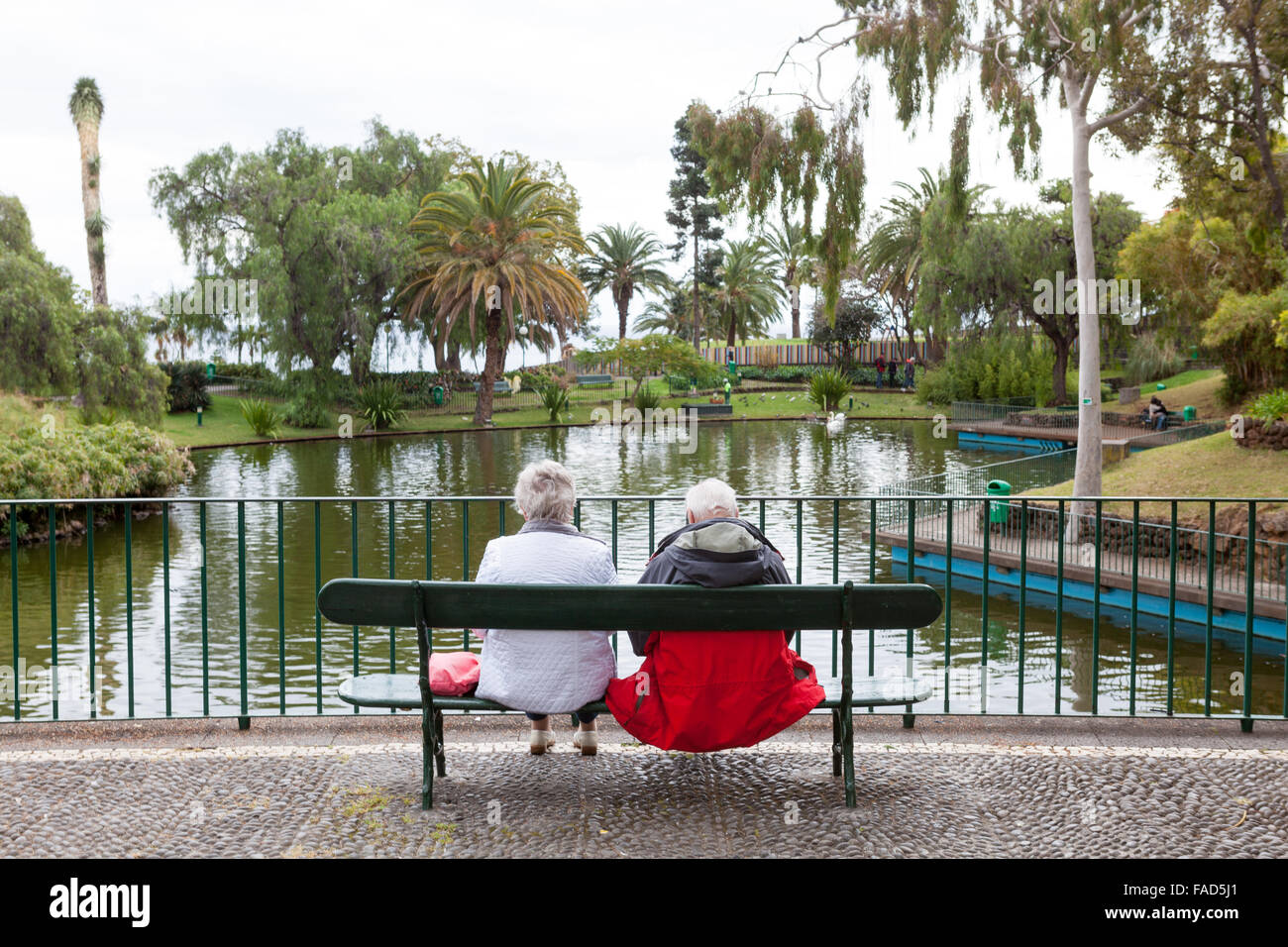 A couple seated on a bench in Santa Catarina Park. Funchal, Madeira Stock Photo