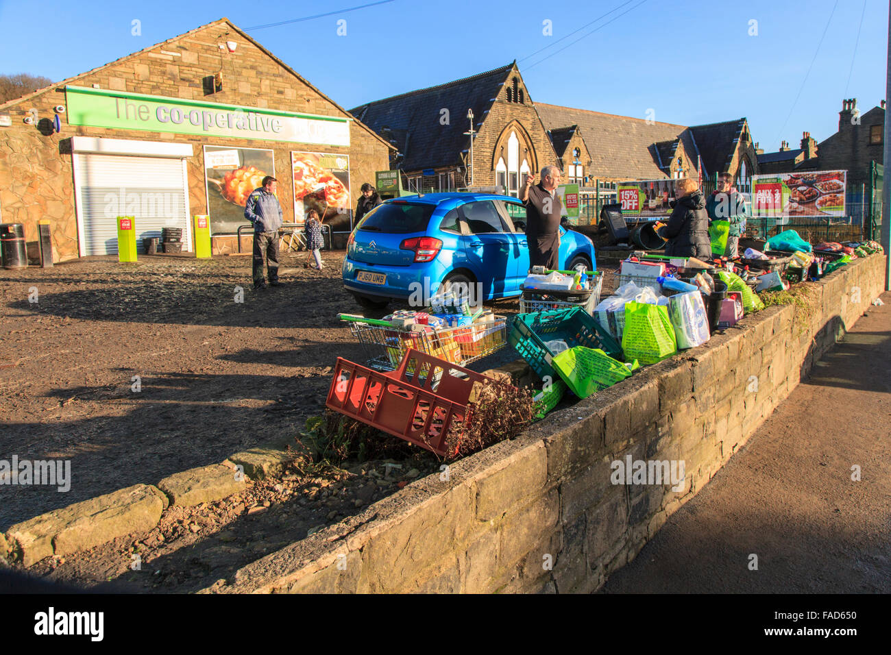 Mytholmroyd, UK, 27th Dec, 2015. Staff giving away free cleaning products outside the Co-Operative supermarket in Mytholmroyd, following flooding on Boxing day 2015 Credit:  Graham Hardy/Alamy Live News Stock Photo