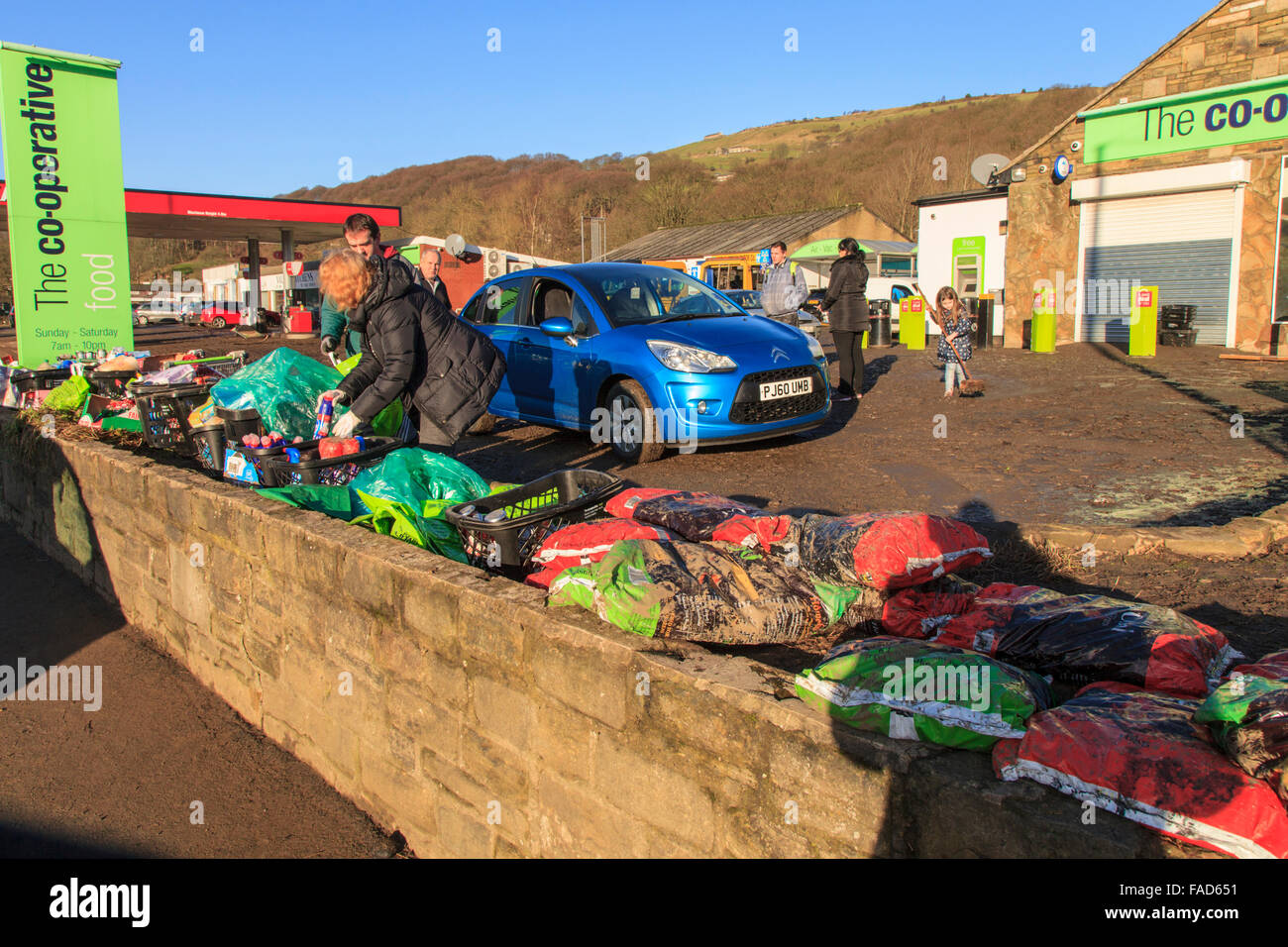 Mytholmroyd, UK, 27th Dec, 2015. Staff giving away free cleaning products outside the Co-Operative supermarket in Mytholmroyd, following flooding on Boxing day 2015 Credit:  Graham Hardy/Alamy Live News Stock Photo