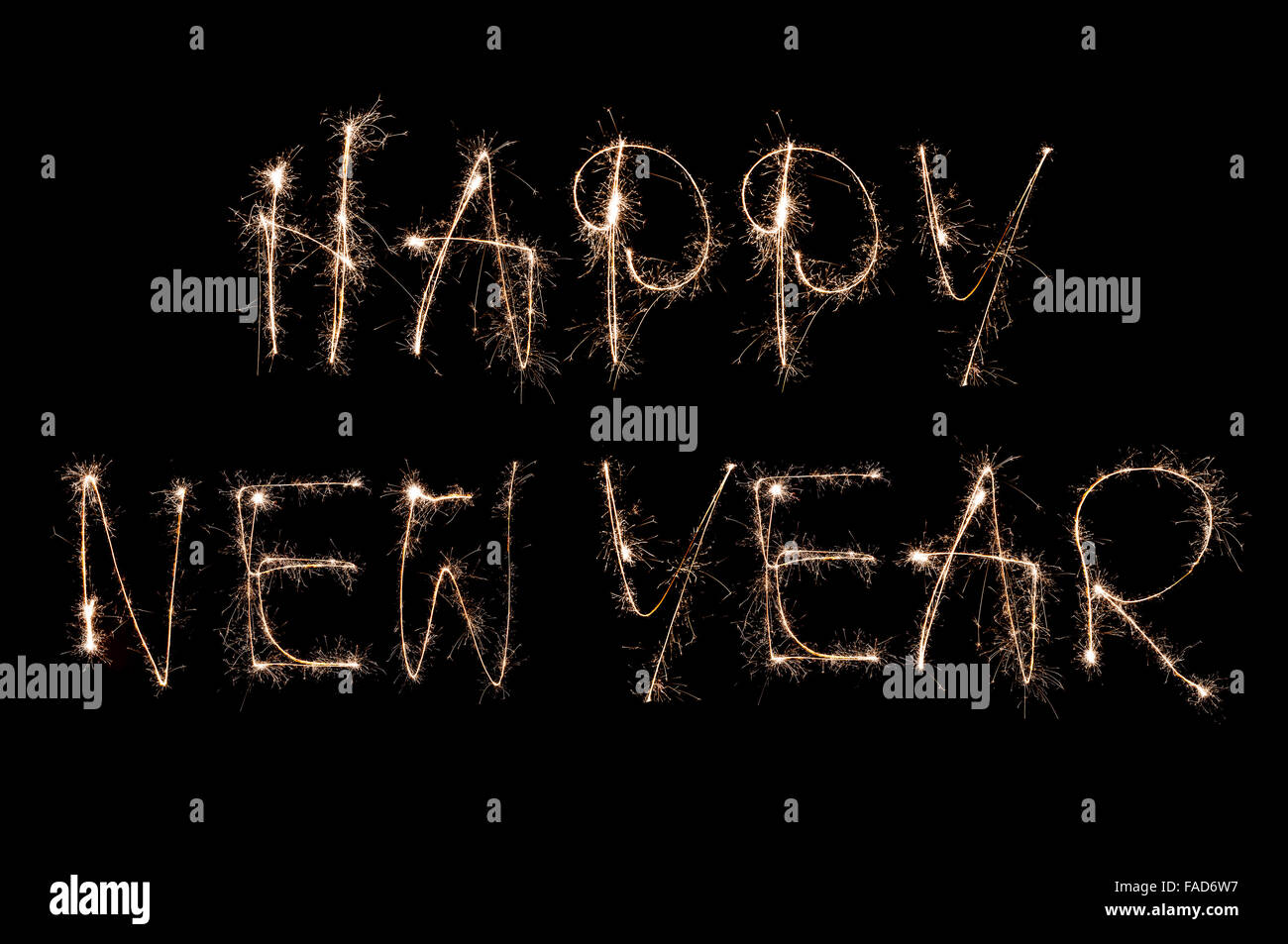 Sparkling happy new year handwritten text on black background Stock