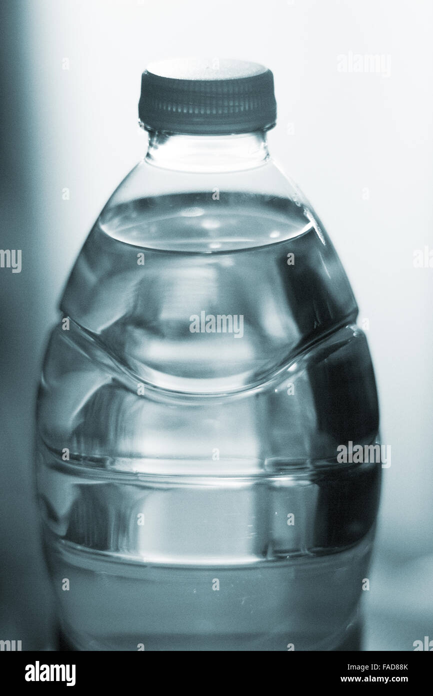 Plastic water bottle at night in light photo Stock Photo - Alamy