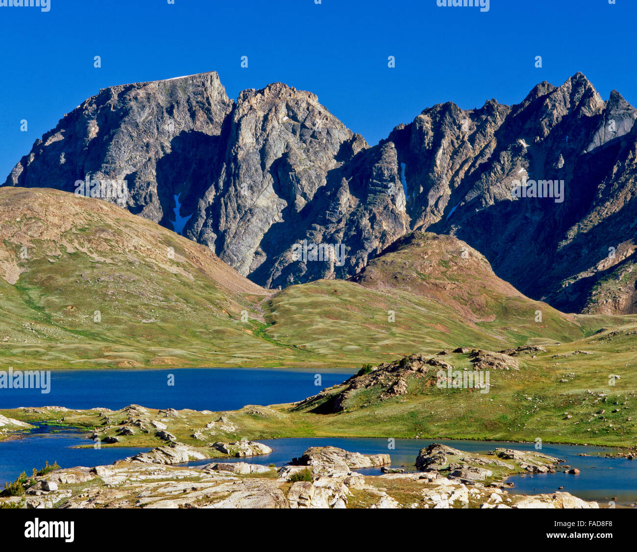 goose lake below wolf and sawtooth peaks in the beartooth range near