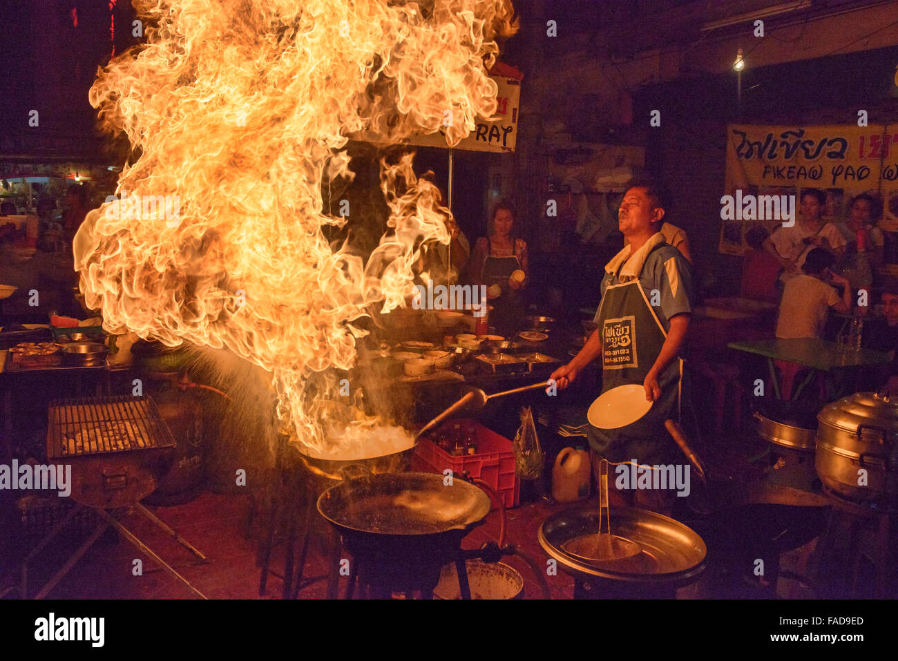 Crazy chef cooking morning glory with massive flames in Chinatown in Bangkok, Thailand Stock Photo
