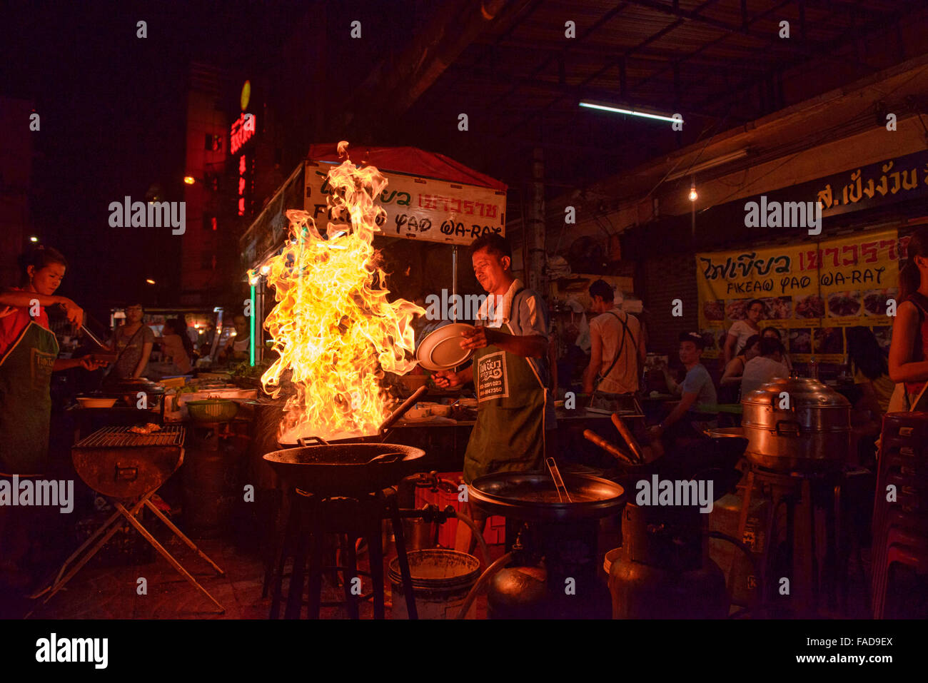 Crazy chef cooking morning glory with massive flames in Chinatown in Bangkok, Thailand Stock Photo