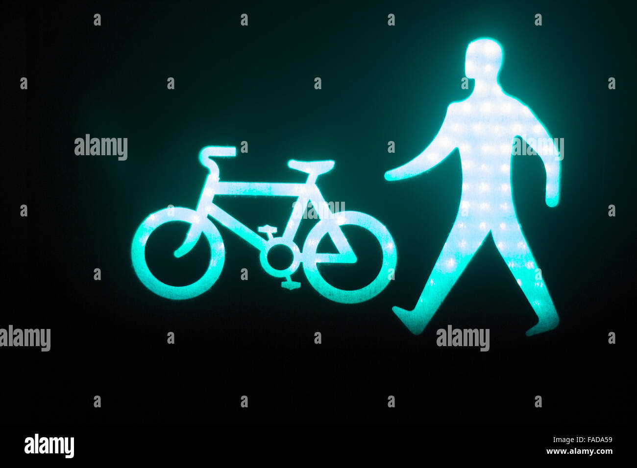 Green man go pedestrian and cycle traffic light sign Stock Photo - Alamy