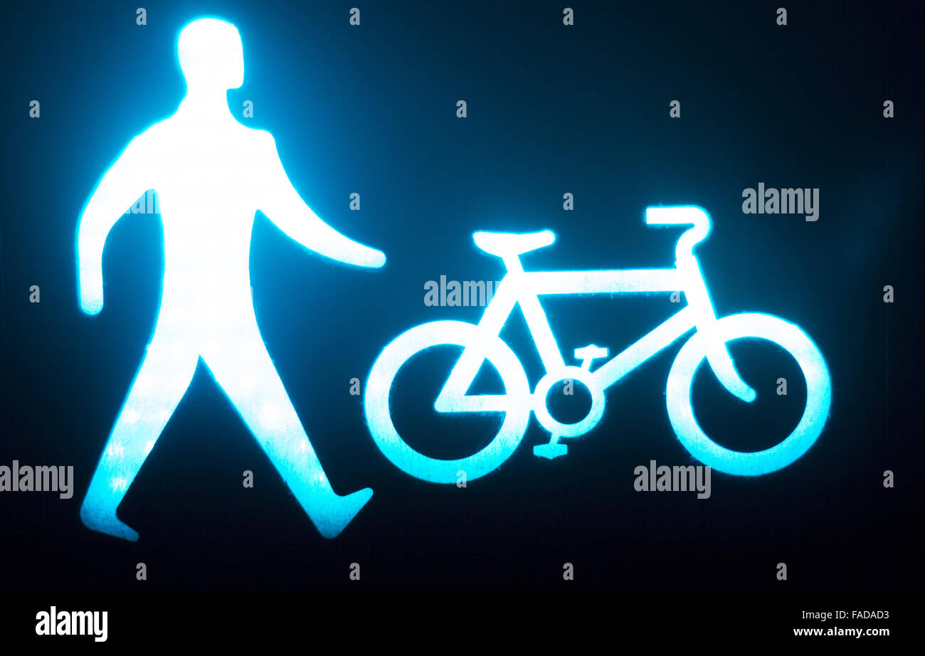 Green man go pedestrian and cycle traffic light sign Stock Photo - Alamy