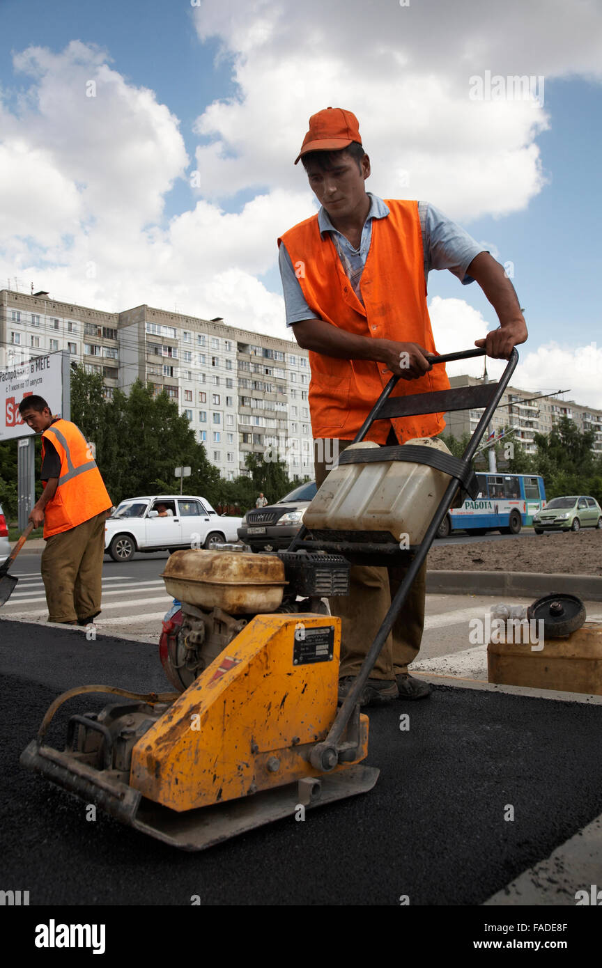 Workers Putting Down Asphalt With Machine Stock Photo Alamy