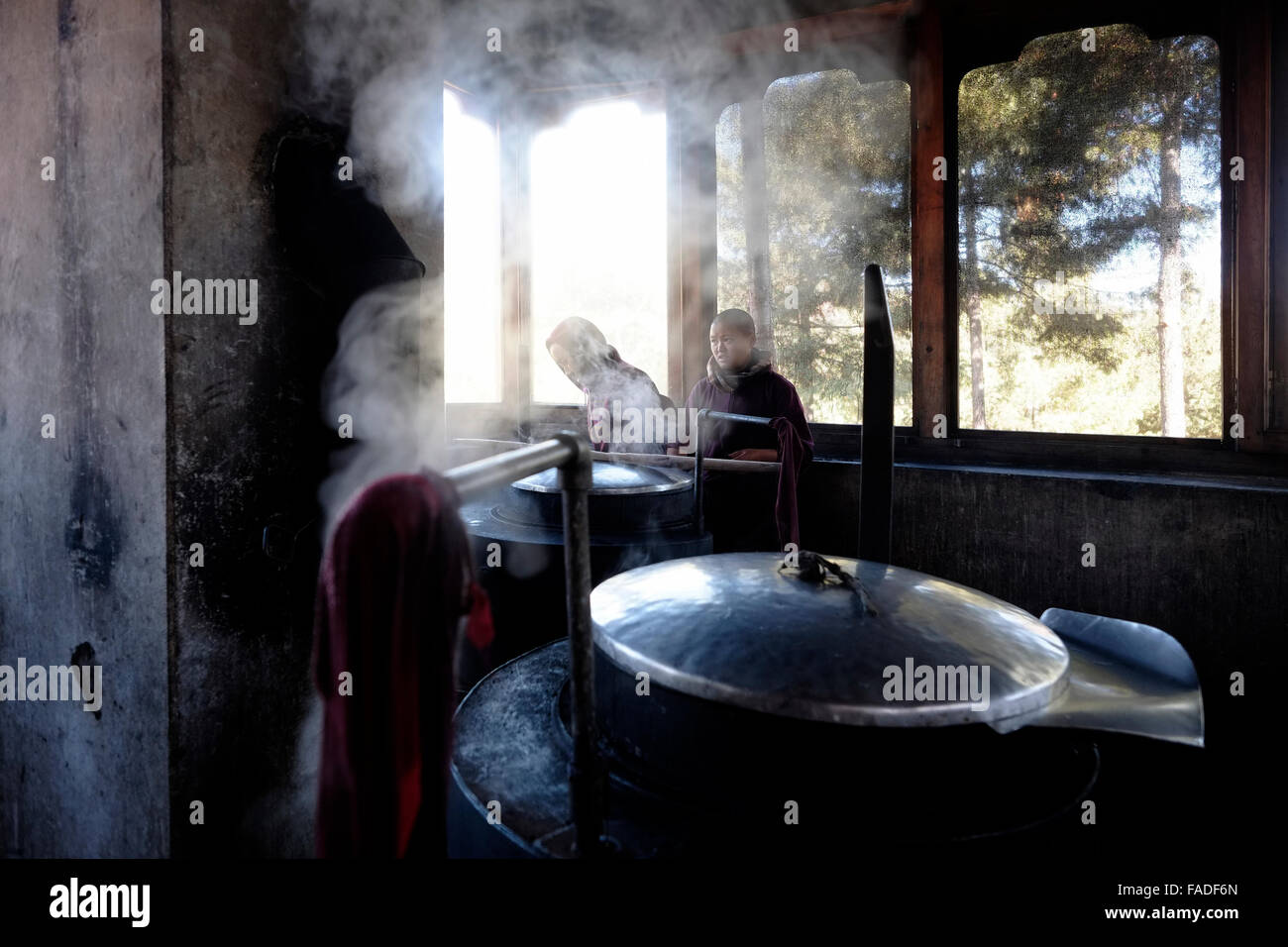 Buddhist nuns cooking in the kitchen of Pema Choling Nunnery in Bumthang in Tang valley in Bhutan Stock Photo
