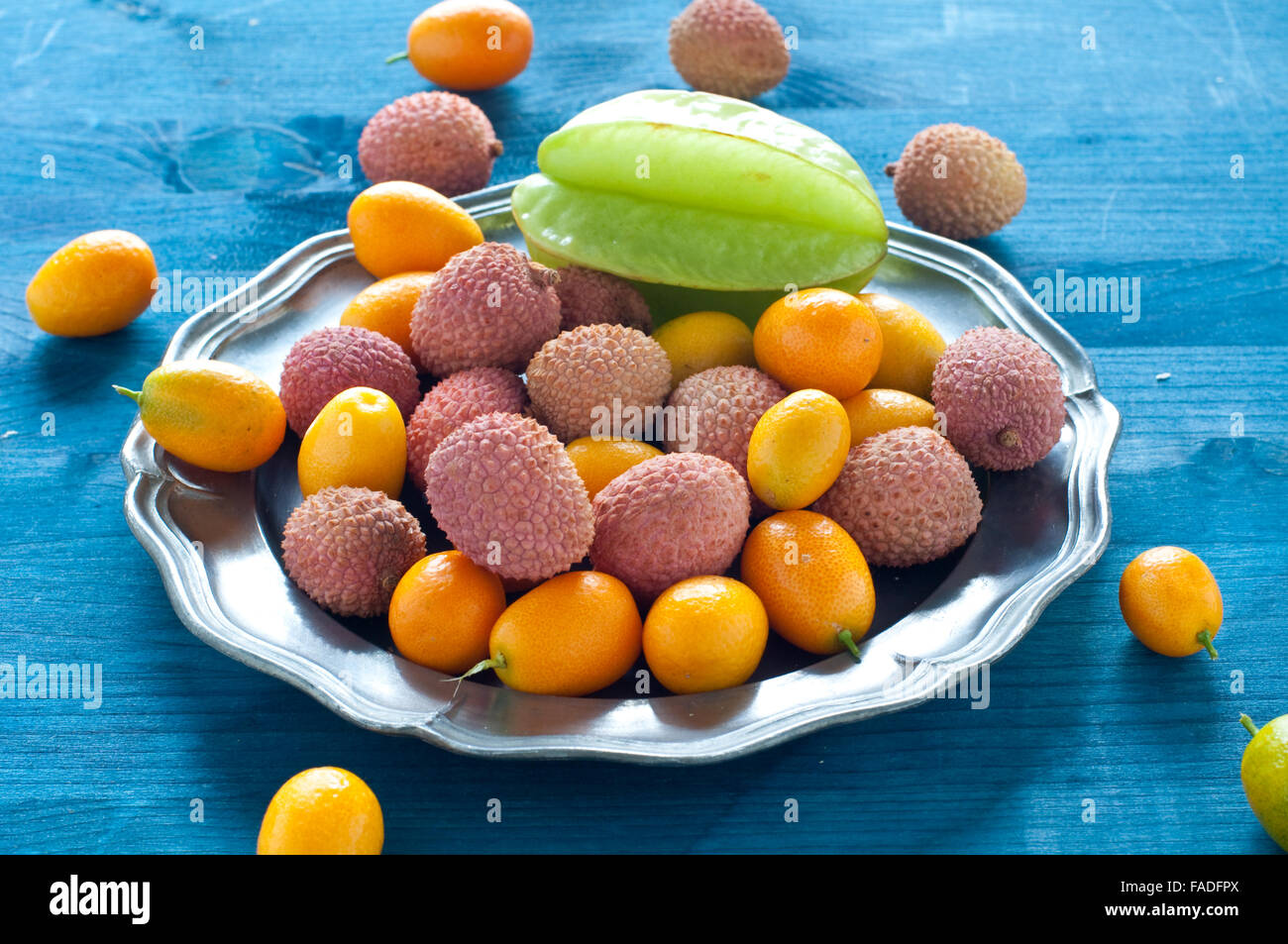 Tropical fruit plate with lychees, kumquats and carambola fruit,italy