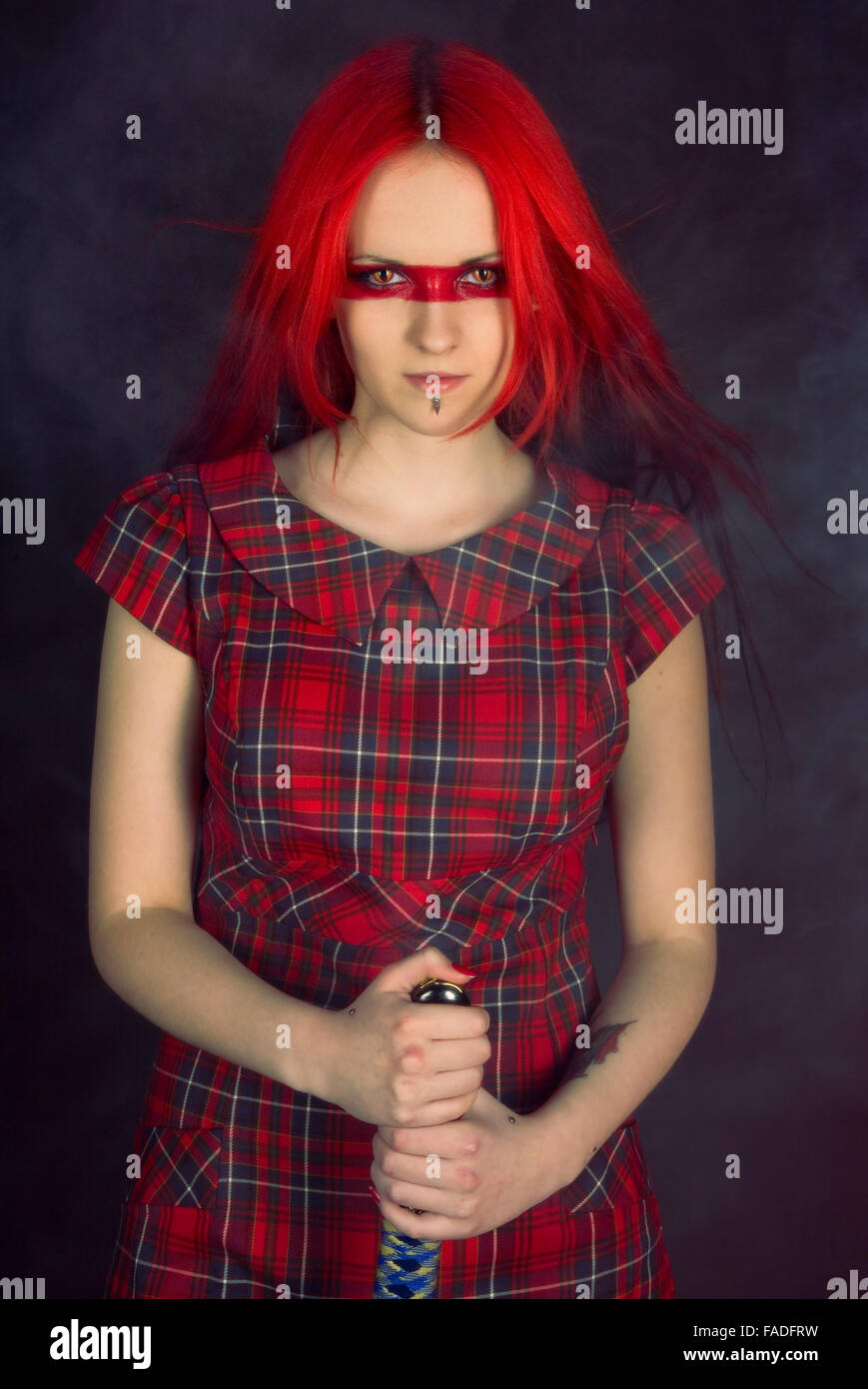 Girl with red hair and a Japanese sword Stock Photo - Alamy