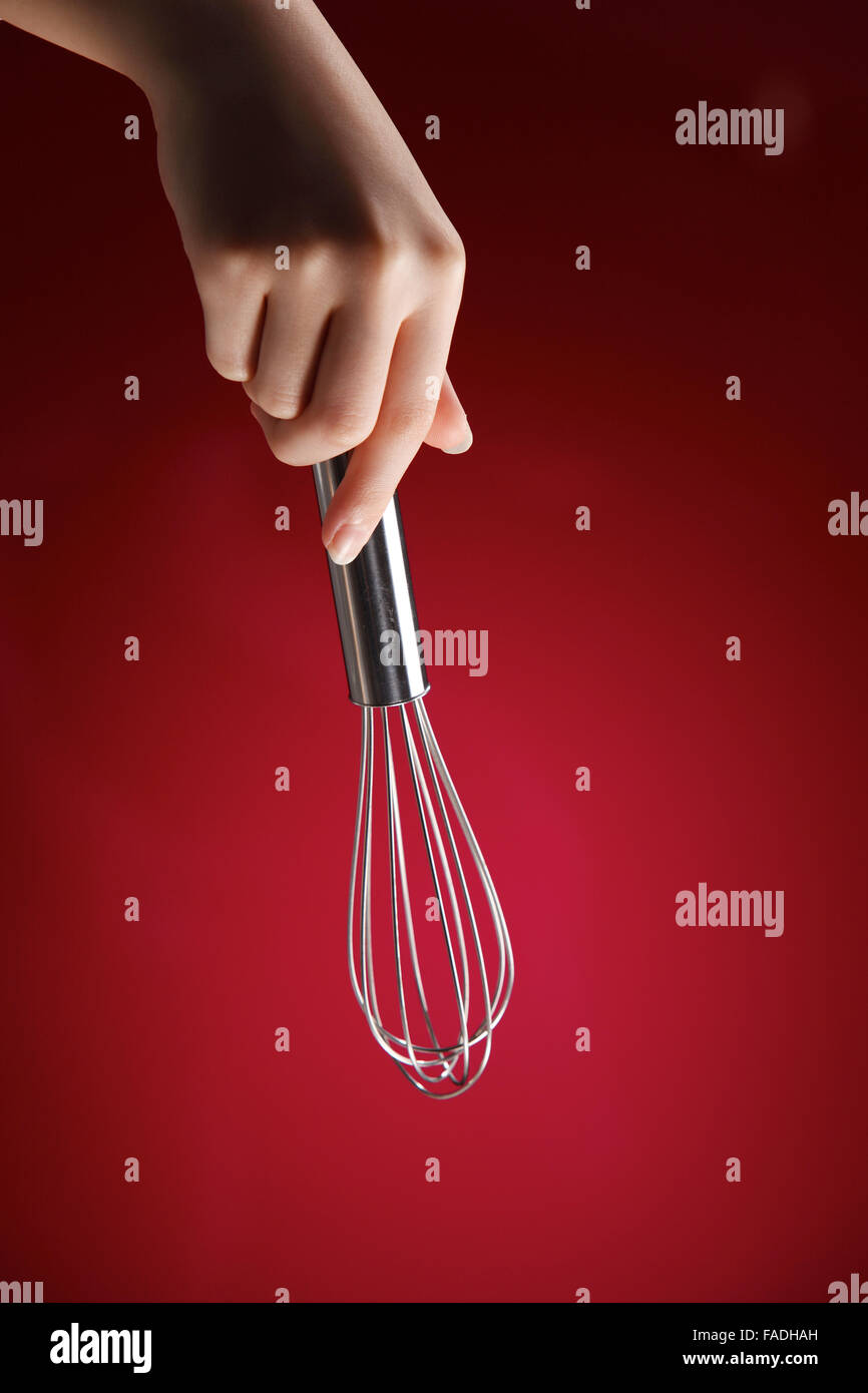 child holding a wire whisk Stock Photo Alamy