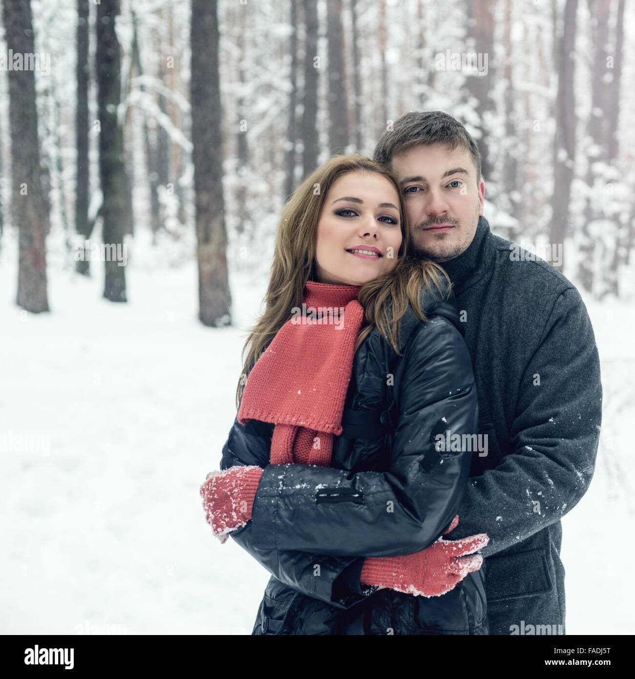 Portrait of happy couple in winter park Stock Photo - Alamy