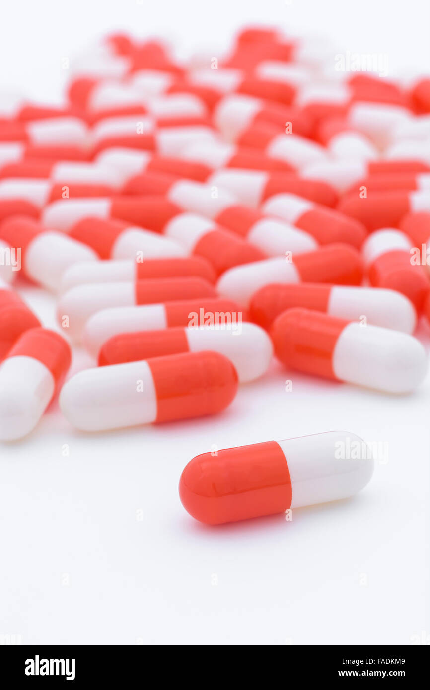Closeup of orange and white pills capsule form made of gelatin. Big