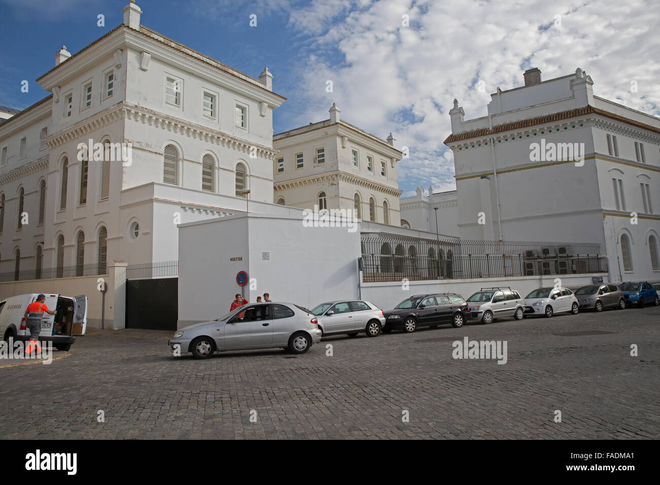 Pure white buildings in Cadiz Spain with cars parked outside Stock