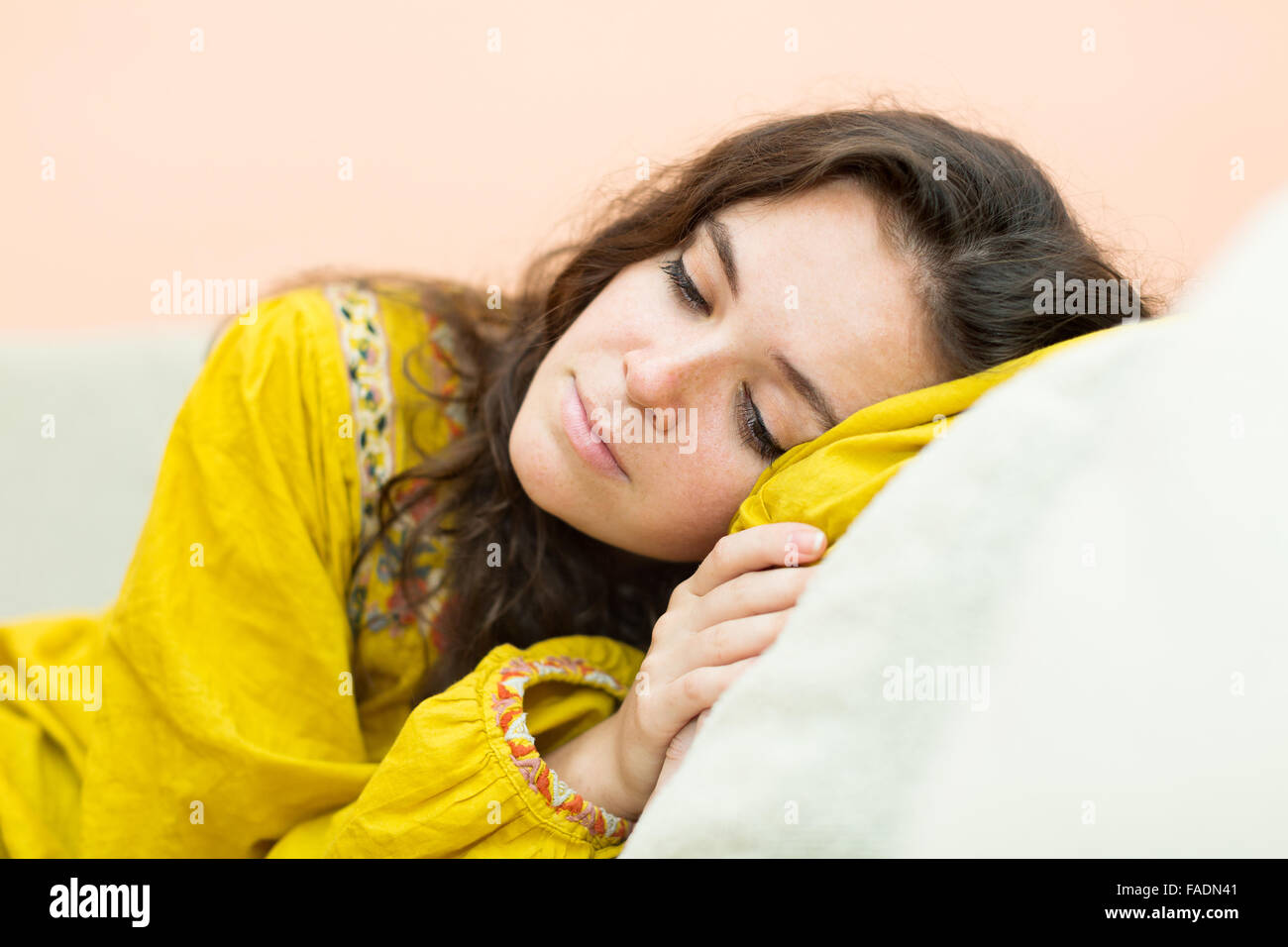 Sad brunette girl on the couch at home Stock Photo - Alamy