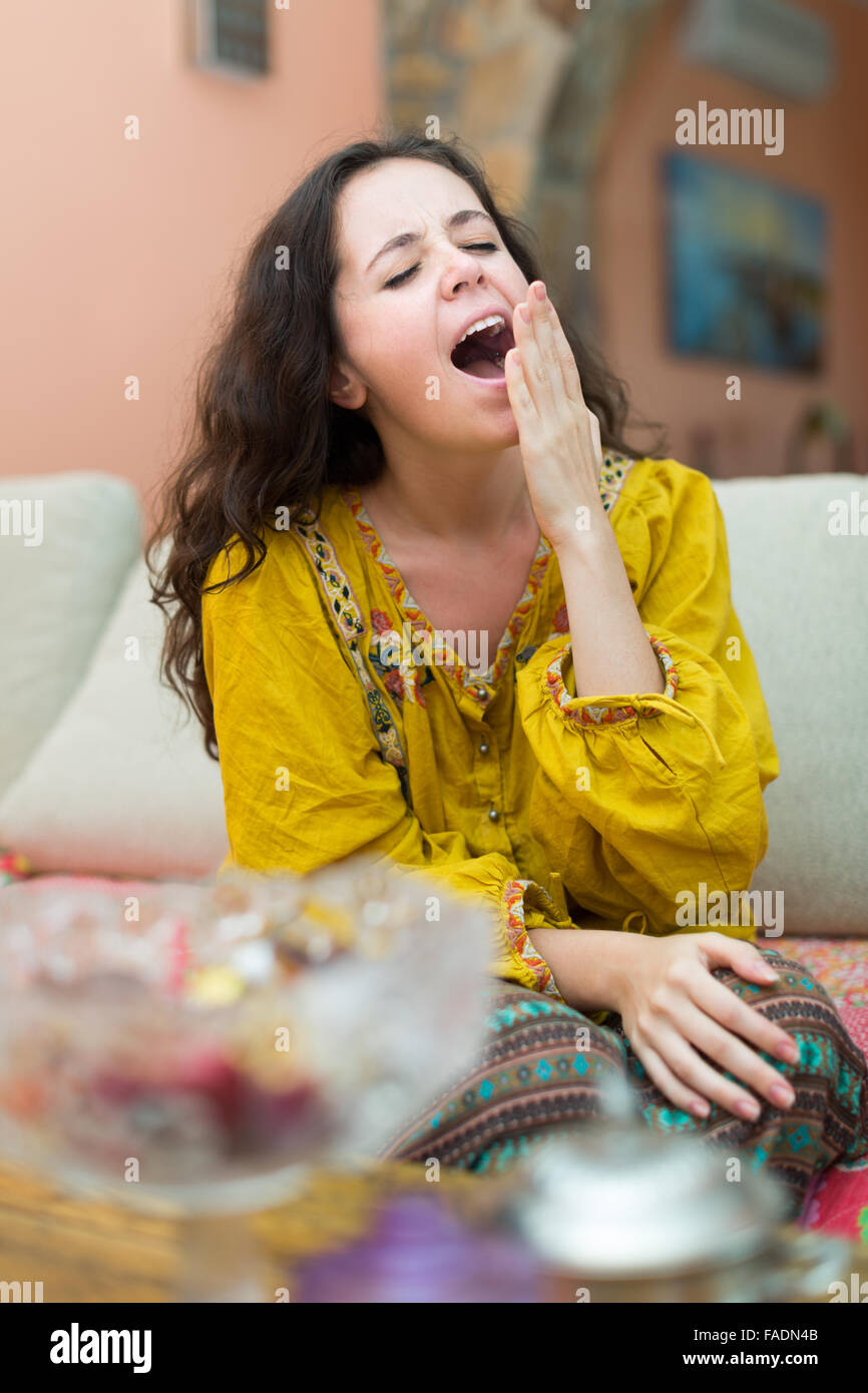 Attractive girl sitting on sofa hi-res stock photography and images - Alamy
