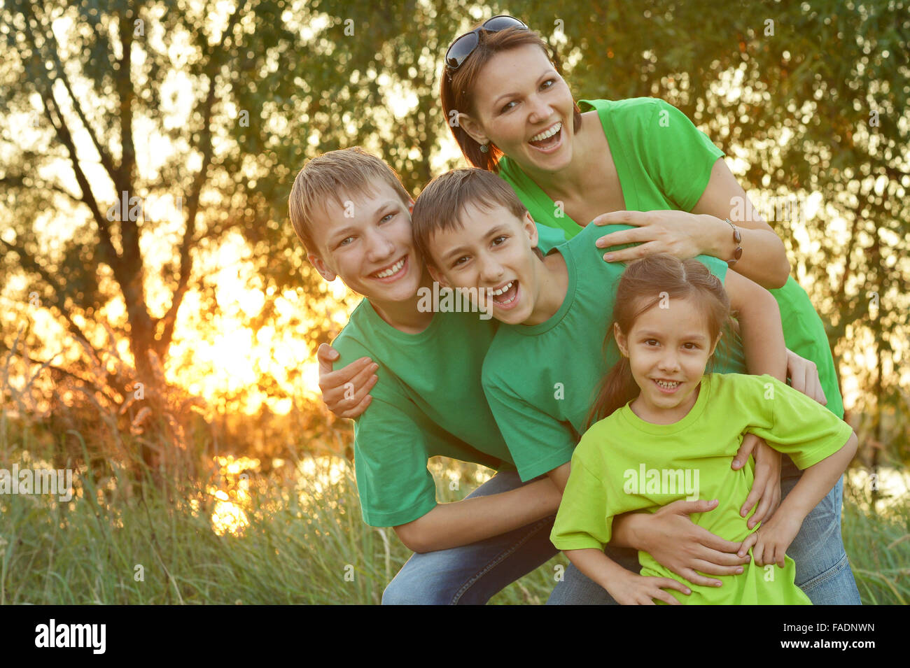 Happy family resting in park Stock Photo - Alamy