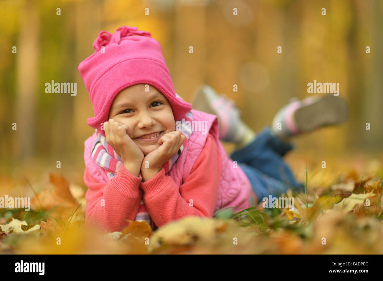 lying on leaves girl Stock Photo