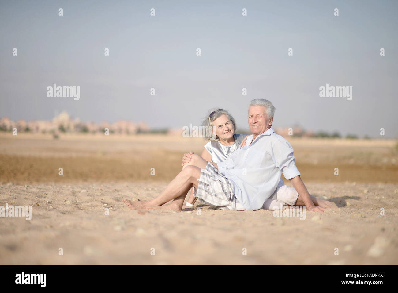 Older couple relaxing on beach hi-res stock photography and images - Alamy
