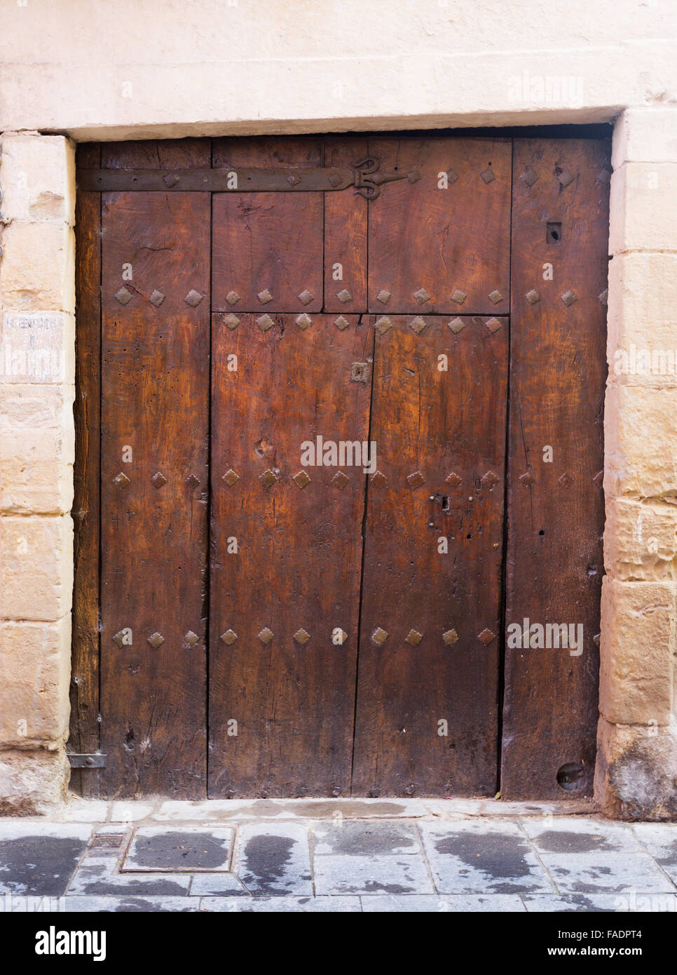 Aged wooden door in stone wall Stock Photo - Alamy
