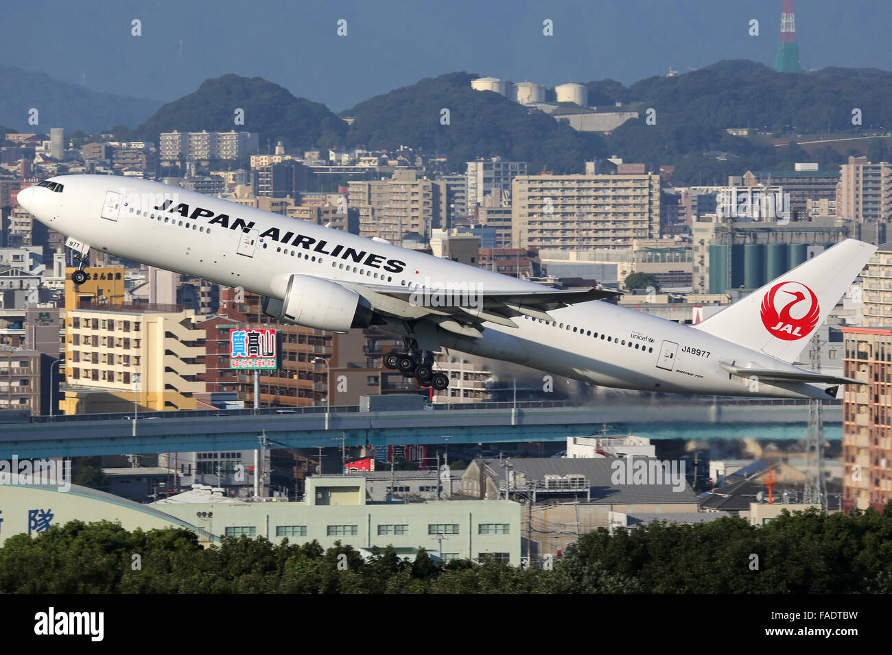 Fukuoka, Japan - October 13, 2015: A Japan Airlines Boeing 777-200 with the registration JA8977 takes off from Fukuoka Airport ( Stock Photo