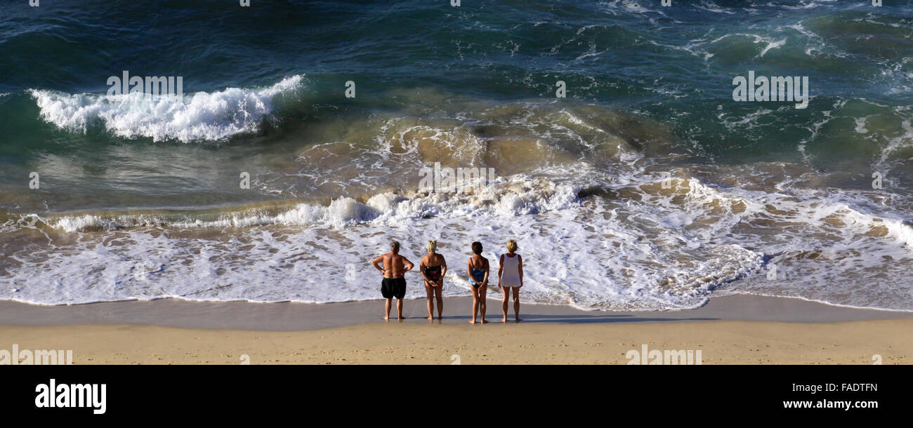 Tourists enjoy the summerly weather on the beach near Morro Jable on