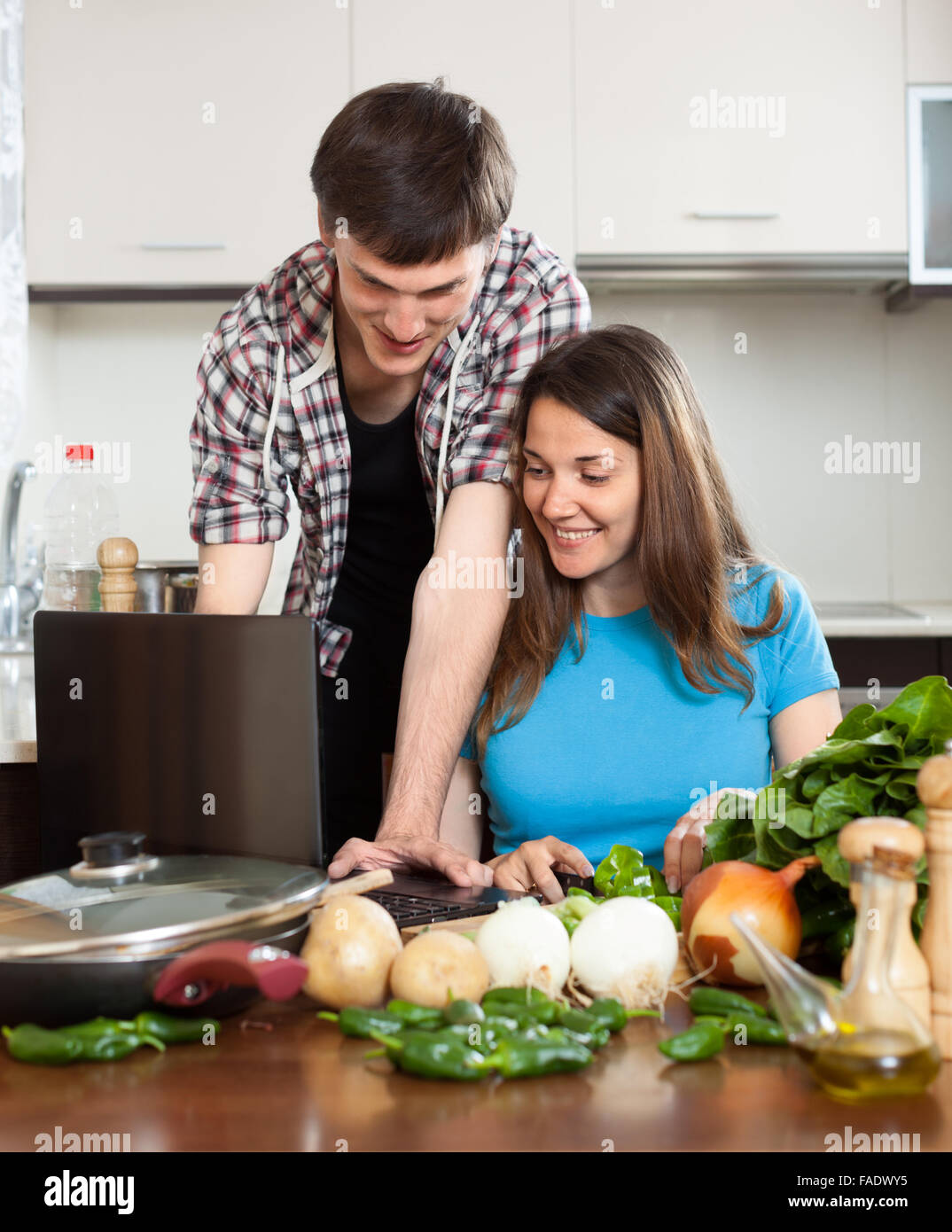 Couple laptop in kitchen hi-res stock photography and images - Alamy