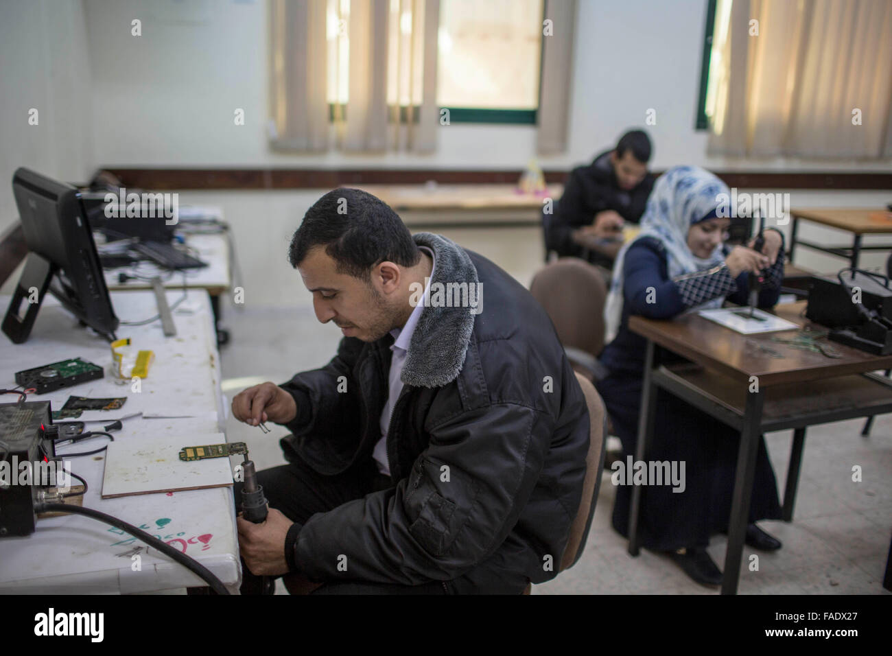 Gaza, Gaza City. 28th Dec, 2015. Disabled people work at the training center of the Irada Institution, in Gaza City, on Dec. 28, 2015. The center provides disabled people with 3-6 months of vocational training and temporary job opportunities so they can better cope with hardships in life. Credit:  Wissam Nassar/Xinhua/Alamy Live News Stock Photo