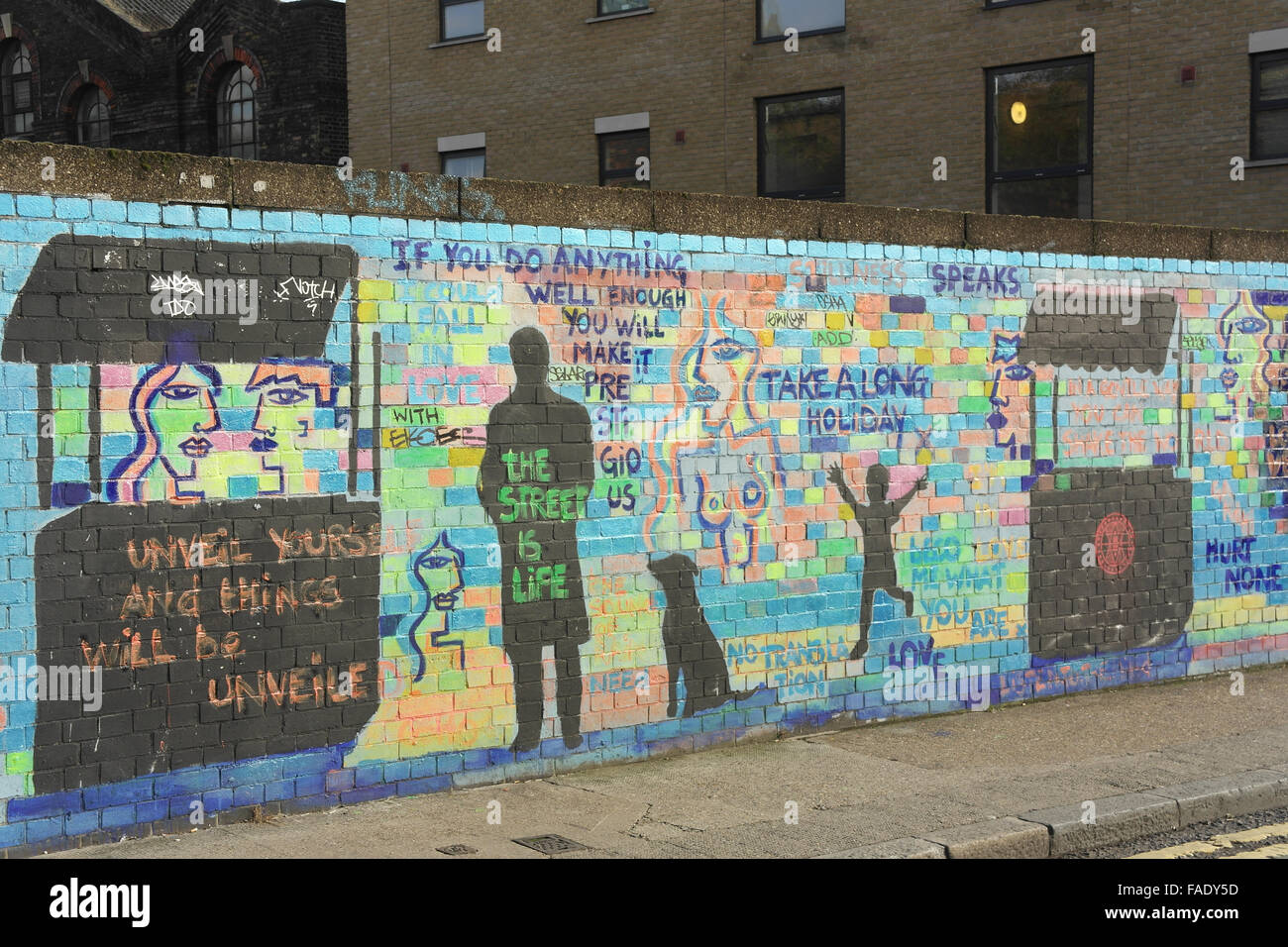 Multicoloured brick wall with life captions, black stencils shop