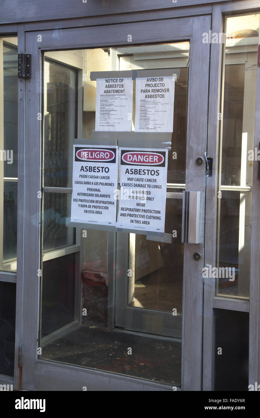 Posted warning signs of Asbestos in a building scheduled to be gutted for renovation. Brooklyn, NY. Stock Photo
