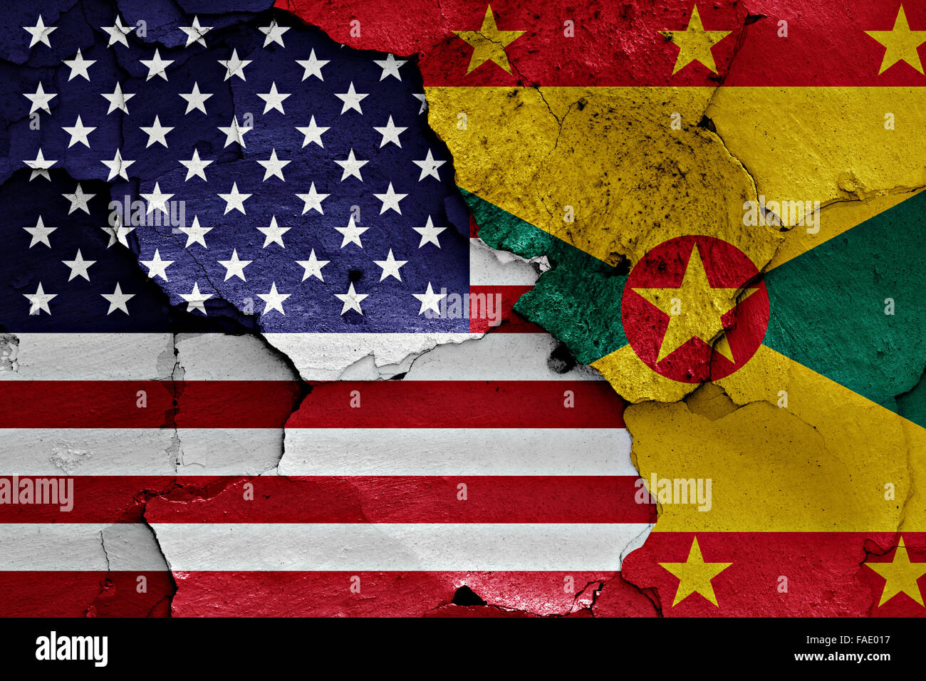 flags of USA and Grenada painted on cracked wall Stock Photo