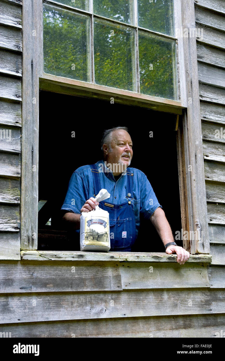 Craft person demonstrating how to make corn meal at Mingus Mill in Great Smoky Mountain National Park, North Carolina, USA. Stock Photo
