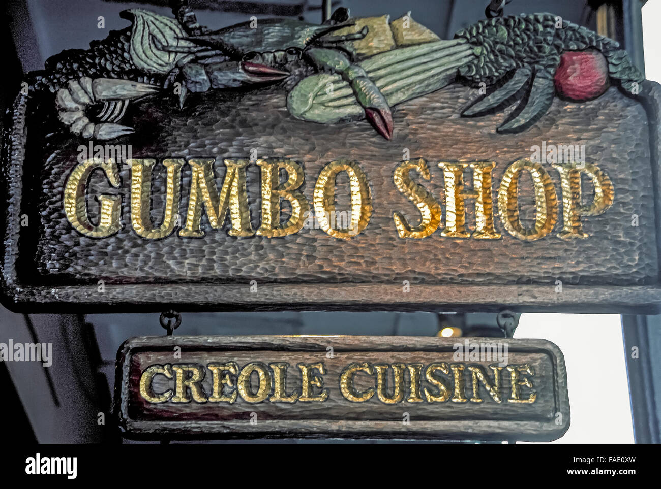 An outdoor street sign advertises the Gumbo Shop, a casual French Quarter restaurant specializing in Creole cuisine in New Orleans, Louisiana, USA. A favorite dish on the menu is its namesake okra-based soup, gumbo, featuring a choice of main ingredients: shrimp and crabs or chicken and Andouille, a Cajun sausage. The delicious soup also includes onion, bell peppers, celery, tomato and seasonings. Stock Photo