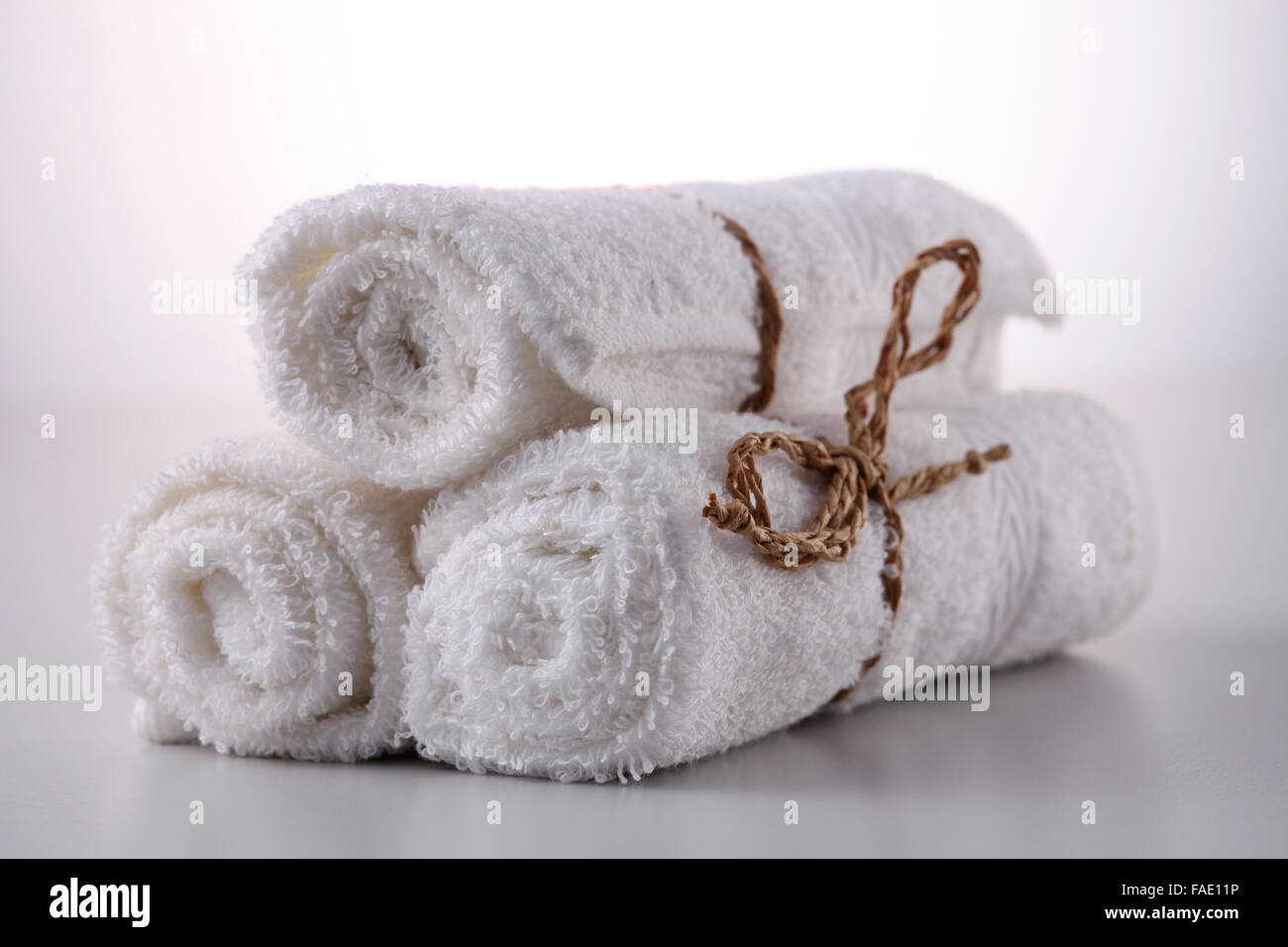 Three white towels rolled into pyramid shape Stock Photo