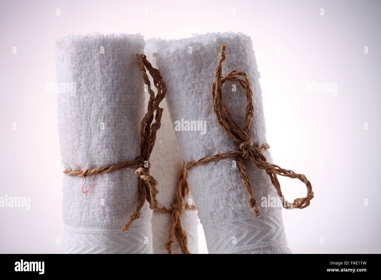 Three white towels rolled into pyramid shape Stock Photo