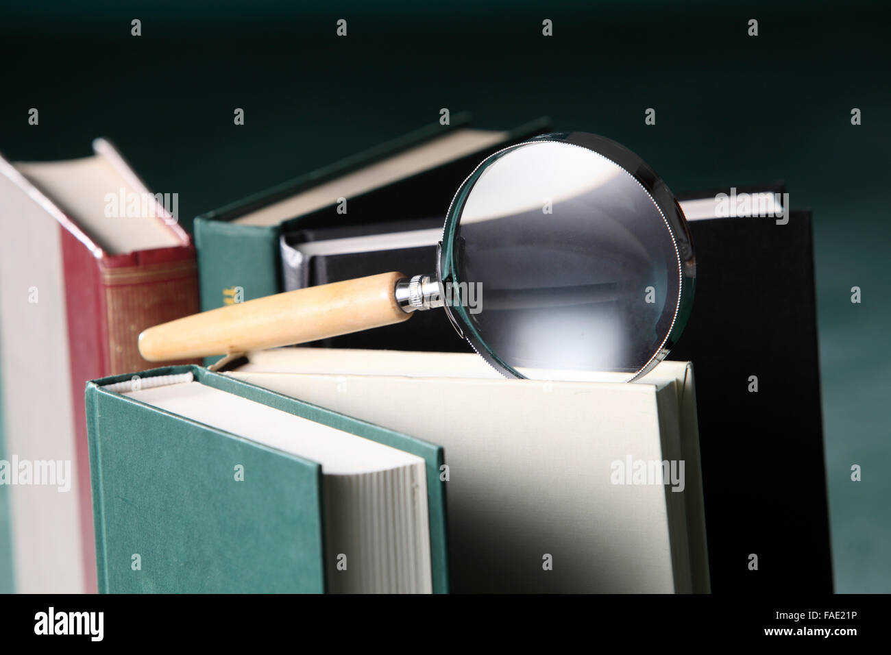 magnifying glass on the book Stock Photo - Alamy