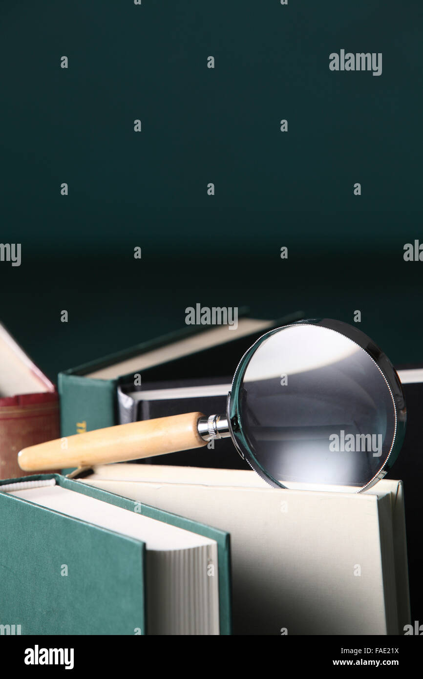 magnifying glass on the book Stock Photo - Alamy