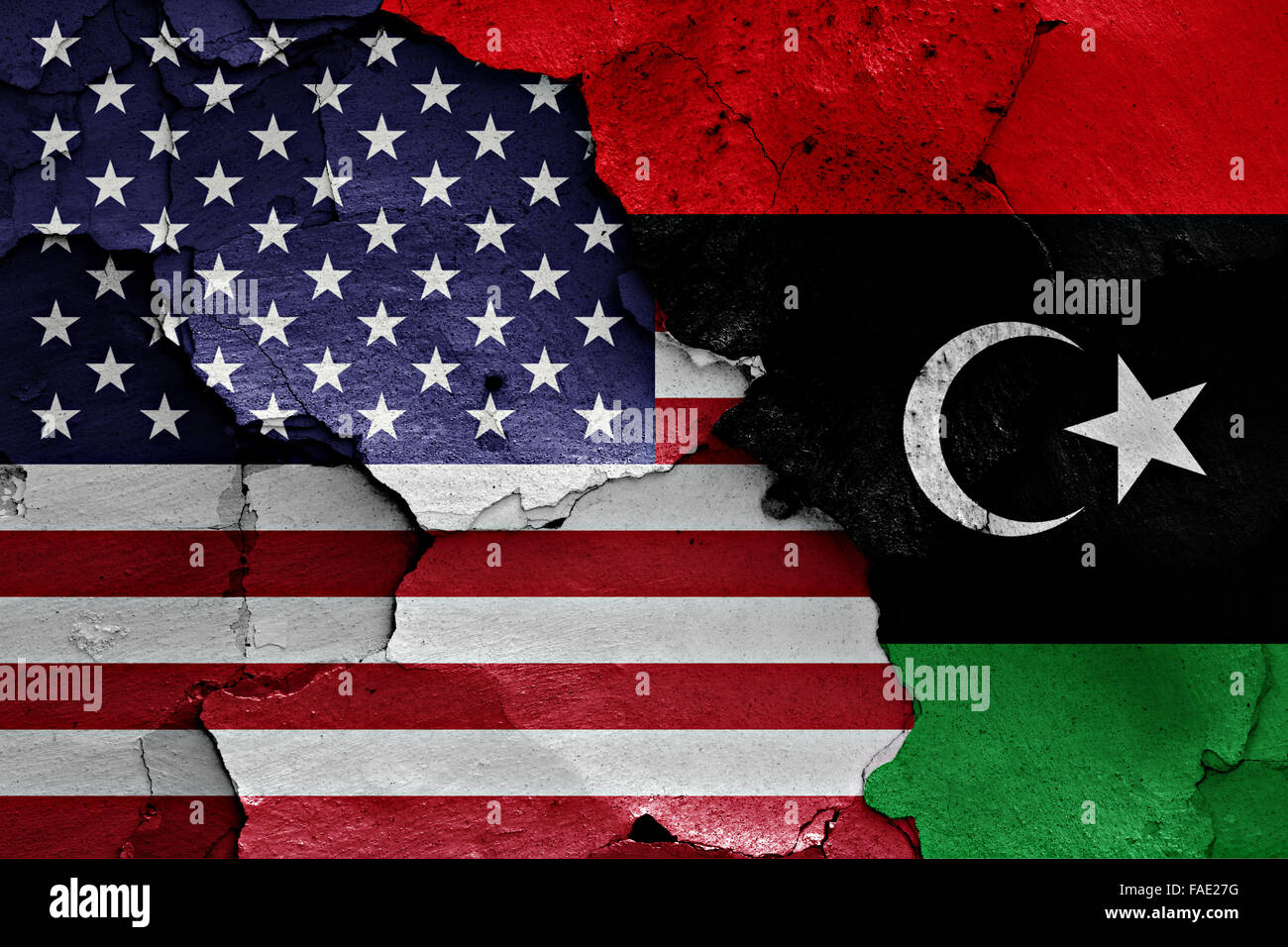flags of USA and Libya painted on cracked wall Stock Photo