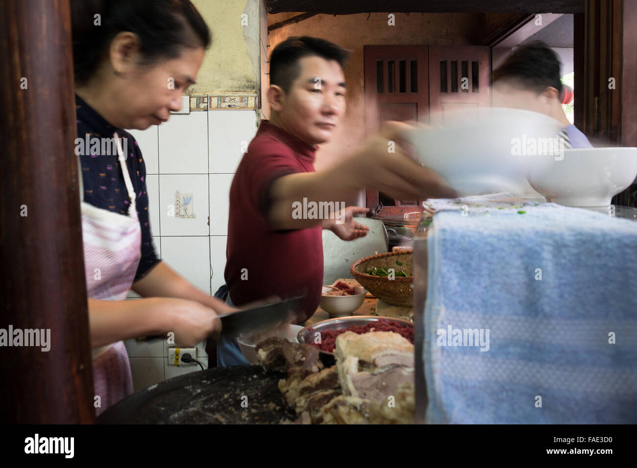 Staff preparing bowls of Pho Bo (beef noodle soup) at the iconic Pho Gia Truyen at 49 Bat Dan in Hanoi's Old Quarter. Stock Photo